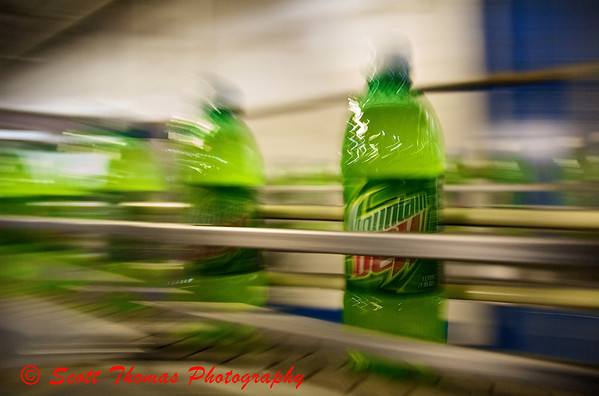 Mountain Dew bottles moving down a conveyor to be shipped out to stores. Mountain Dew bottle moves down a conveyor to be shipped out to stores.