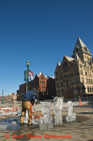 Ice carver, Adam Vural, uses 300 pound blocks of ice to create sculptures in Clinton Square during Syracuses Winterfest.