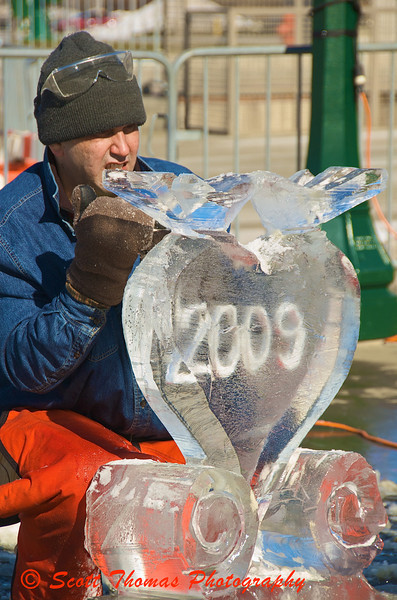 Ice carver Adam Vural puts the finishing touches to a Valentines Day themed sculpture.