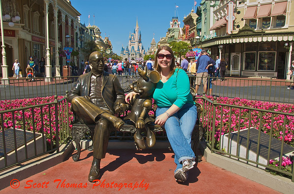 Sitting with Roy Disney.  My daughter sits with Walt Disneys brother and Minnie Mouse in the Magic Kingdom, Walt Disney World, Orlando, Florida.