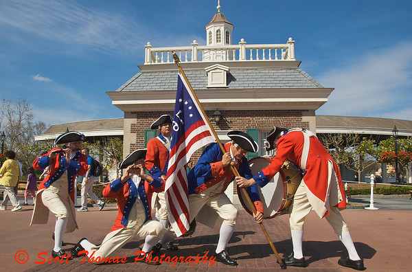 The Spirit of America Fife and Drum Corps saluting the US Marine Corps in front of the American Adventure pavilion in Epcots World Showcase.
