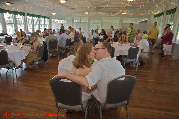 The Wedding Couple share a kiss before friends and family at their reception. The Wedding Couple share a kiss before friends and family at their reception.