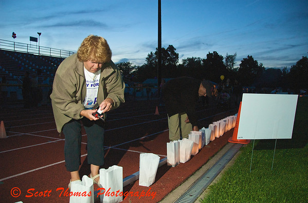 Volunteers help light the luminaries as darkness falls over the Baldwinsville, New York, Relay for Life Cancer fund raiser at the Pelcher-Arcaro Stadium on Friday, June 19, 2009. Volunteers help light the luminaries as darkness falls over the Baldwinsville, New York, Relay for Life Cancer fund raiser at the Pelcher-Arcaro Stadium on Friday, June 19, 2009.